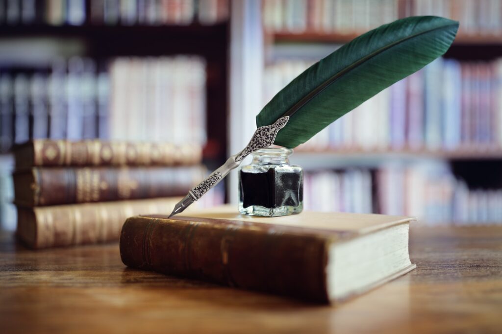 Quill pen on an old book in a library